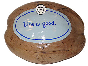 The Life is Good logo painted on a coconut for an unusual advertising specialty marketing promotion